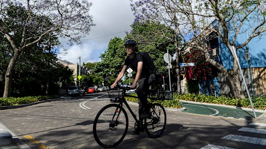 University student Jed Finnane navigates the Wilson Street cycleway in Redfern.