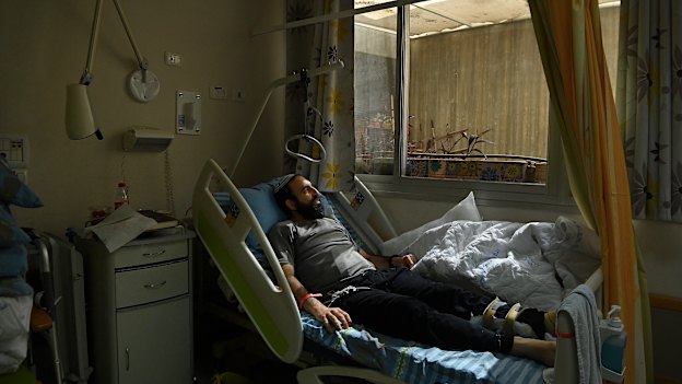 Rabbi Shachar Butzchak being treated in the Soroka Medical Centre for bullet wounds in his leg after being shot during the Hamas attack in Ofakim, Israel.