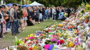 Members of the public at a makeshift memorial for the victims of the mosque mass murders at Botanical Gardens in Christchurch.