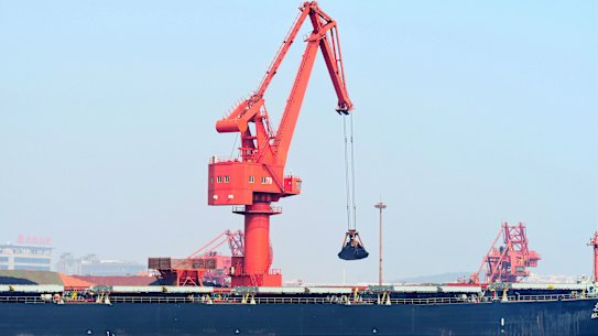 Iron ore is unloaded at Qingdao port in April.