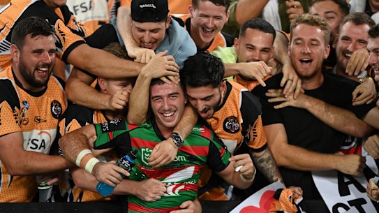 Rabbitohs utility Dean Hawkins mobbed by his junior club teammates after his debut game. 2021 NRL Round 05 - South Sydney Rabbitohs v Brisbane Broncos, Stadium Australia, 2021-04-08. Digital image by 