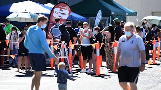 People queue to receive a COVID-19 vaccine at Bunnings in Brisbane last month.