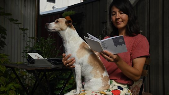 Illustrator Kim Siew looks back at one her many zines. She’s pictured with her dog, Alfie.