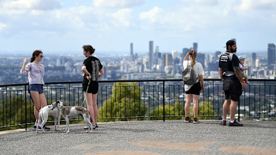 Visitors take in the view from the Mt Coot-Tha lookout.