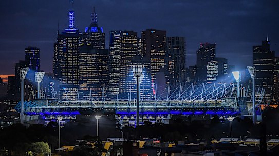 The MCG and city buildings turn blue in tribute to the four police officers who died on the Eastern Freeway a year ago today. 