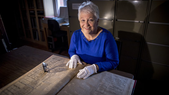 Janine Rizzetti of the Heidelberg Historical Society pores over old copies of the Heidelberg News and Diamond Creek Chronicle.