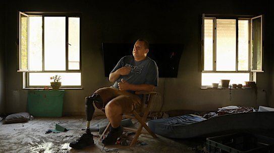 Avida Bahar, who lost his right leg after being shot by Hamas, sits in his home where his wife, Dana, and son, Carmel, were killed and daughter, Hadar, was wounded by Hamas during the October 7 attack on Kibbutz Be’eri.