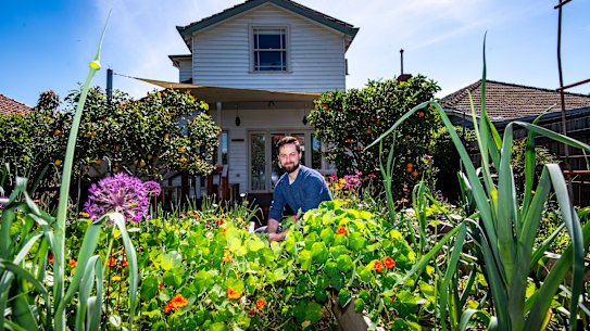 Tom Midwood in the backyard of his new home.