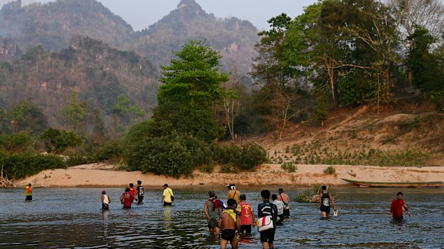 A group of men from Pu Lu Palaw village cross the Moei River back into Myanmar, on the border with Thailand. 