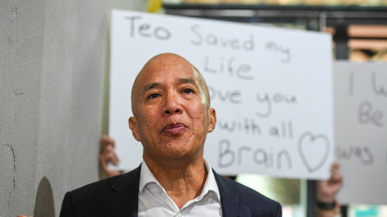 Dr Charlie Teo is surrounded  by supporters when he arrives at the Commission hearing.