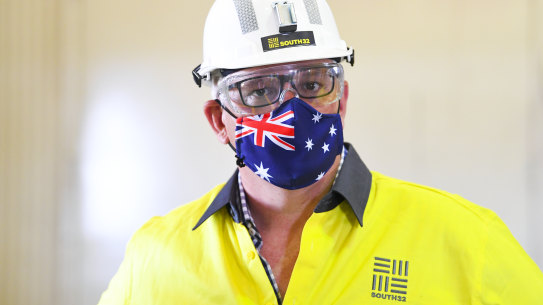 Prime Minister Scott Morrison wears a hard hat and face mask during a visit to South32 Cannington Mine in McKinlay, Queensland on Wednesday.