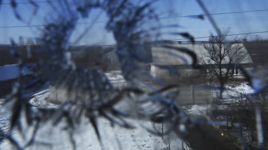 The shattered window of Olena Miroshnychenko’s home that was destroyed when mortars landed in her backyard in Kamyanka village in east Ukraine.