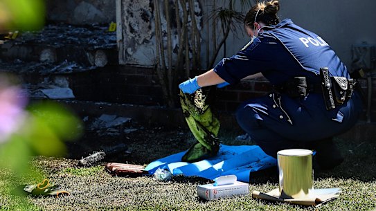 Police at the Guildford West property after the attack.