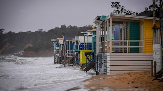 Beach boxes exposed to the sea at Mount Martha North 