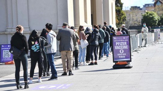 People queue at the Royal Exhibition Building vaccination centre in Carlton on Saturday.