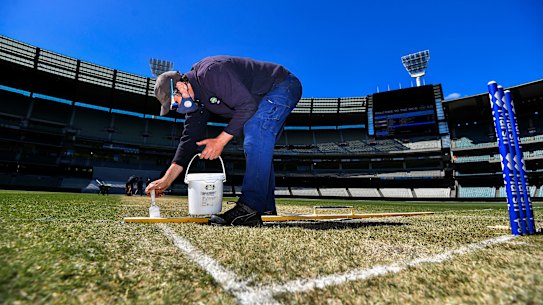 MCG curator Matt Page repaints the MCG lines on Monday.