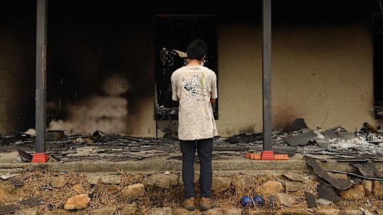 Gabriel gazes into the ruins of the family home.