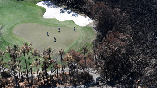 Peregian Springs residents are returning to their normal lives but can see the grim sight of burnt bushland nearby.