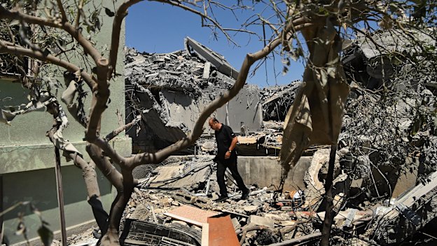 A man walks among the debris of a home destroyed by an Iranian missile strike in the northern Israeli town on Tamra.