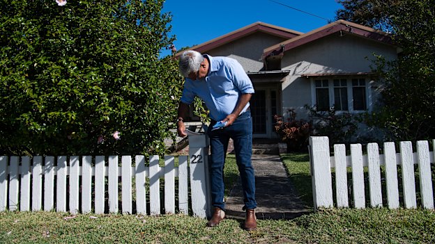 The Liberal candidate for the marginal NSW seat of Gilmore, Warren Mundine, hands out campaign flyers in Bomaderry. 