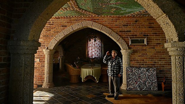 Galliano Callegari gestures towards the murals he has created in his western Sydney home.