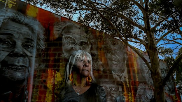Aunty Eva-Jo Edwards stands in front of a mural depicting elders on the Aborigines Advancement League building in Thornbury. She says a treaty would benefit all Victorians.