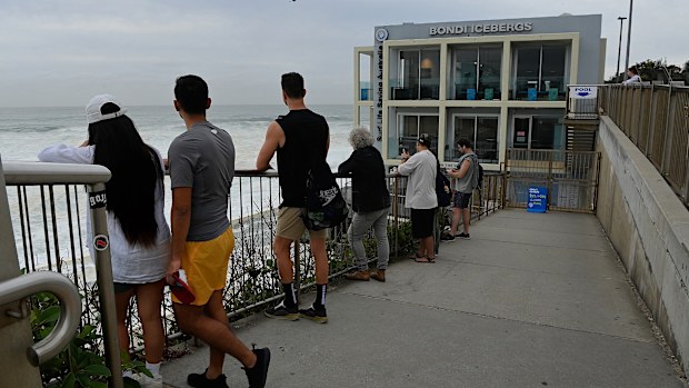 People look out at the ocean at Bondi Icebergs on Bondi Beach that has been closed after it was damaged by dangerous surf conditions. Bondi Beach, Sydney. April 2, 2025. Photo: Kate Geraghty