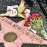 Fans leaving flowers on Olivia Newton-John’s Hollywood Walk of Fame star.