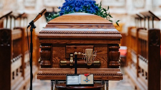 John Laws’ coffin at St Andrew’s Cathedral, flanked by his golden microphones.
