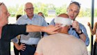 Dutton checks on injured cameraman Ghaith Nadir.