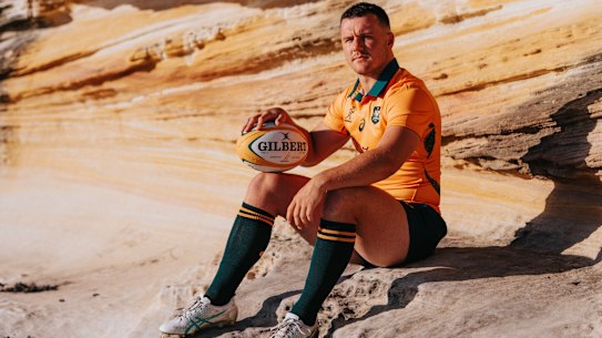 Wiradjuri man Dylan Pietsch models the new Wallabies jersey, which features his artwork.