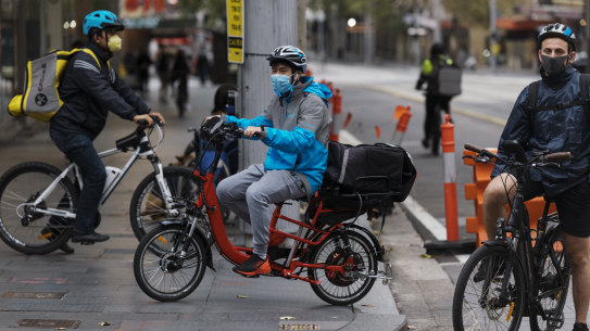 Food Delivery cyclists, working during the Coronavirus isolation lockdown, servicing the Sydney CBD. 