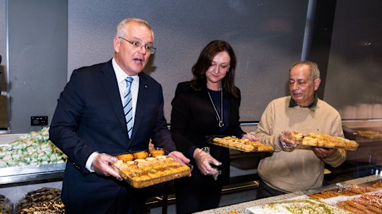 Prime Minister Scott Morrison and Parramatta candidate Maria Kovacic campaigning with business owner Milad Abla in Granville.