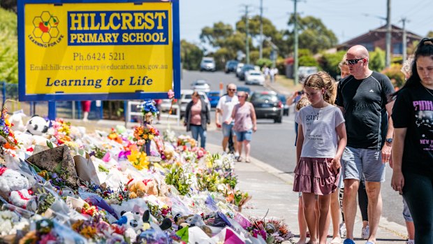 Mourners visit the makeshift memorial site at Hillcrest Primary School.