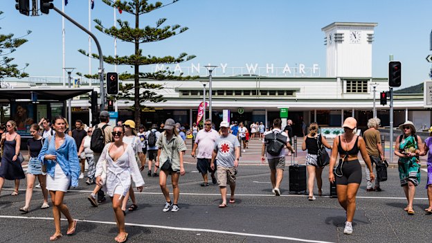 Pedestrians cross the road at Manly wharf.
