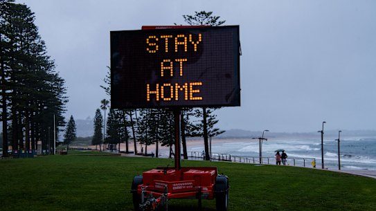A COVID-19 alert sign at Dee Why beach.