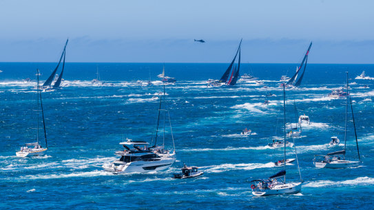Boats sail out of the Heads.