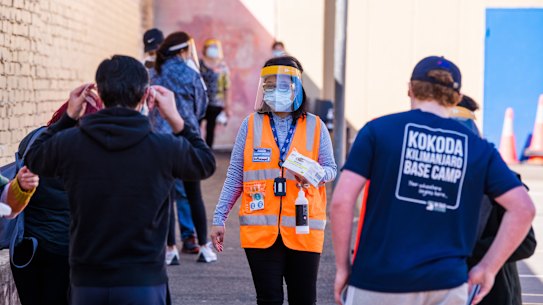 Sydneysiders queue at the pop-up Pfizer vaccination hub for 16 to 59-year-olds at the Peter Forsyth Auditorium, Glebe.