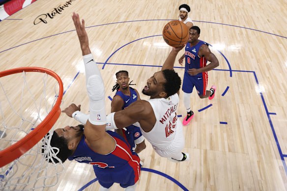 Donovan Mitchell #45 of the Cleveland Cavaliers shoots the ball against Tobias Harris #12 of the Detroit Pistons during the first half in Game Seven of the Second Round of the NBA Eastern Conference Playoffs at Little Caesars Arena in Detroit, Michigan. 
