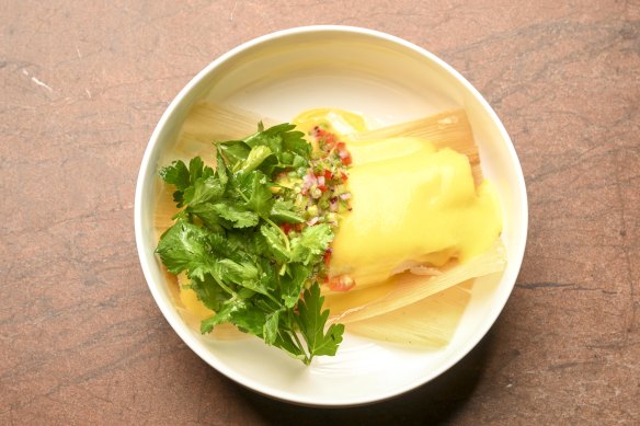 Corn tamale features dough made from ground nixtamalised corn steamed inside corn husks under a corn sauce.