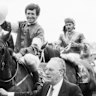  Co-owner, Dennis Gowing, leads Melbourne Cup winner, What a Nuisance with jockey Pat Hyland. 