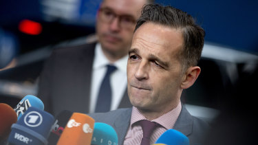 German Foreign Minister Heiko Maas speaks with the media as he arrives for a meeting of EU foreign ministers at the Europa building in Brussels.