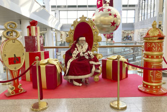 Santa Claus checks his mobile phone as he waits to pose for pictures at a mall in Rome last year.