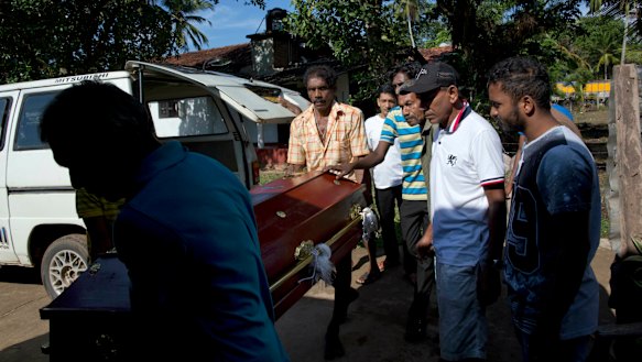 People carry the coffin with the remains of 12-year-old Sneha Savindi, who was a victim of Easter Sunday bombing at St Sebastian Church.
