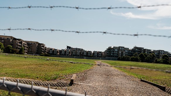 Centenary Park apartments overlook the former landfill site used by Ford motoring company. The fenced-off site was remediated in the 1990s. 