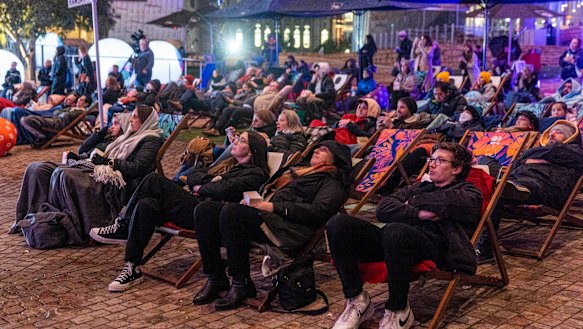 Crowds gather at Federation Square to watch the final episode of Neighbours.