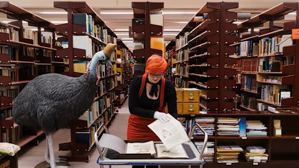 Librarian Adria Castellucci pictured with the book Icones Animalium by Conrad Gessner, published in 1560 and one of the oldest books held in Australia.