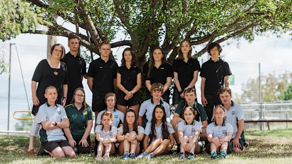 Students from Springwood High cool off in the shade after a hot day in their unairconditioned school