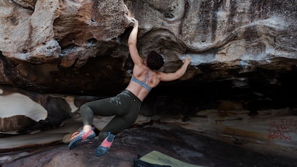 Defaced: Emma Horan boulders at Black Cave near Balgowlah heights, which has been marred by graffiti. 
