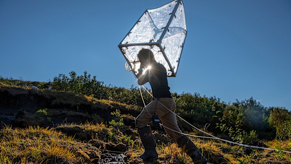 Research technician Philip Hanke moves a measuring chamber that records greenhouse gas fluctuations. 